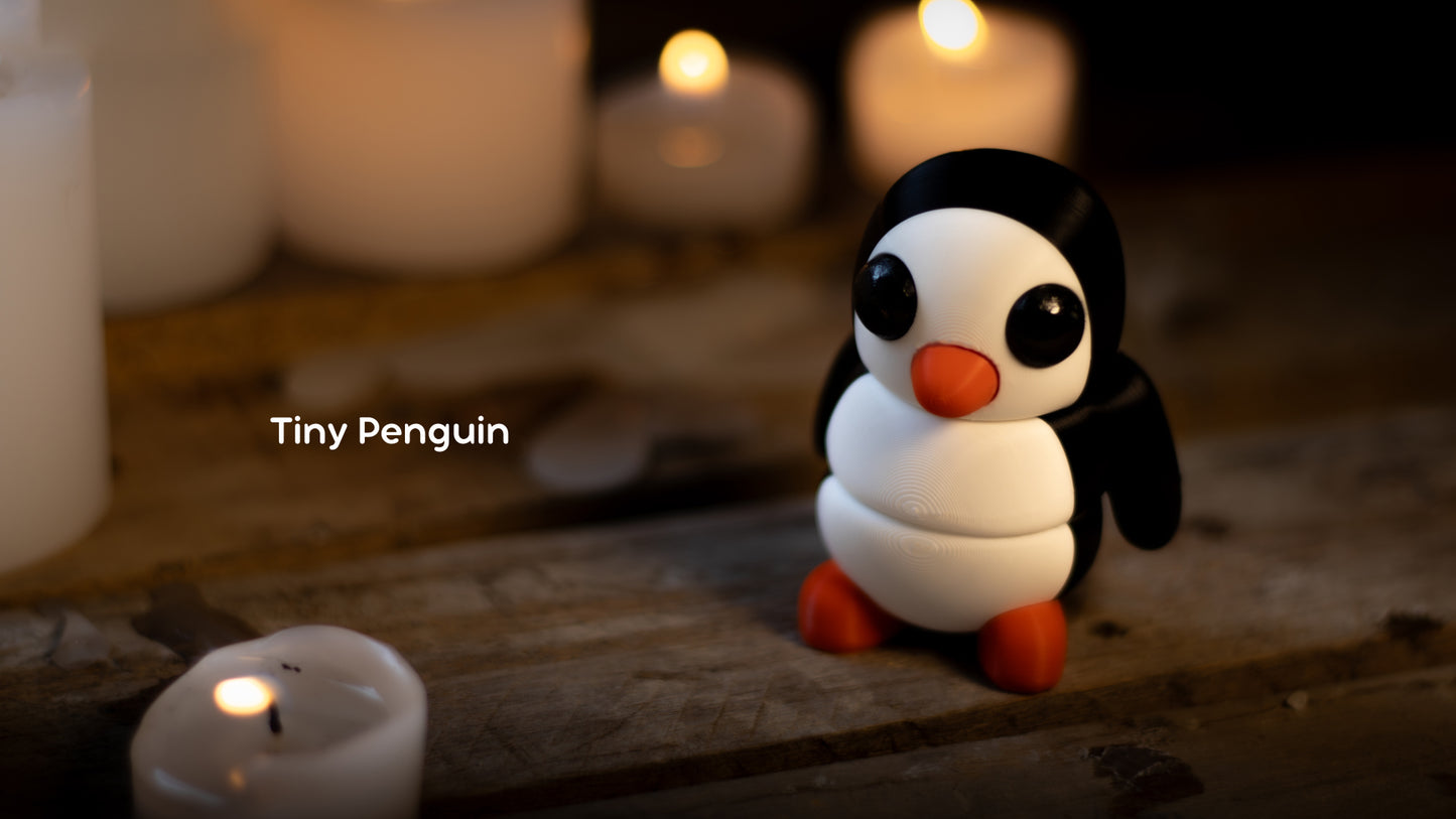 a small penguin sitting next to some candles