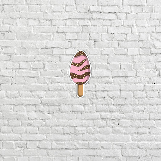 a white brick wall with a pink ice cream on it