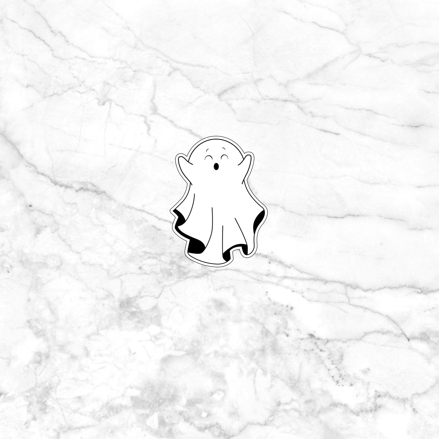 a sticker of a ghost on a marble surface