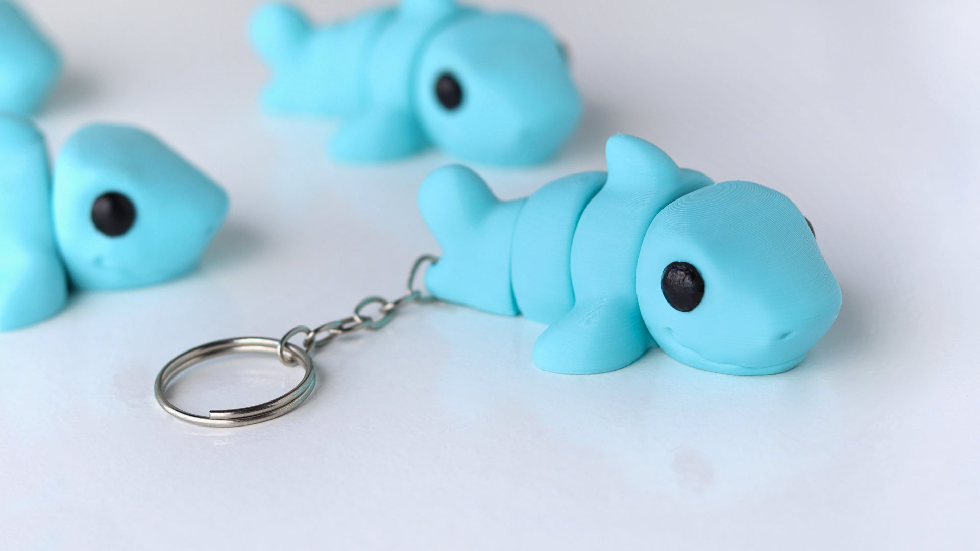 a group of blue plastic fish key chains