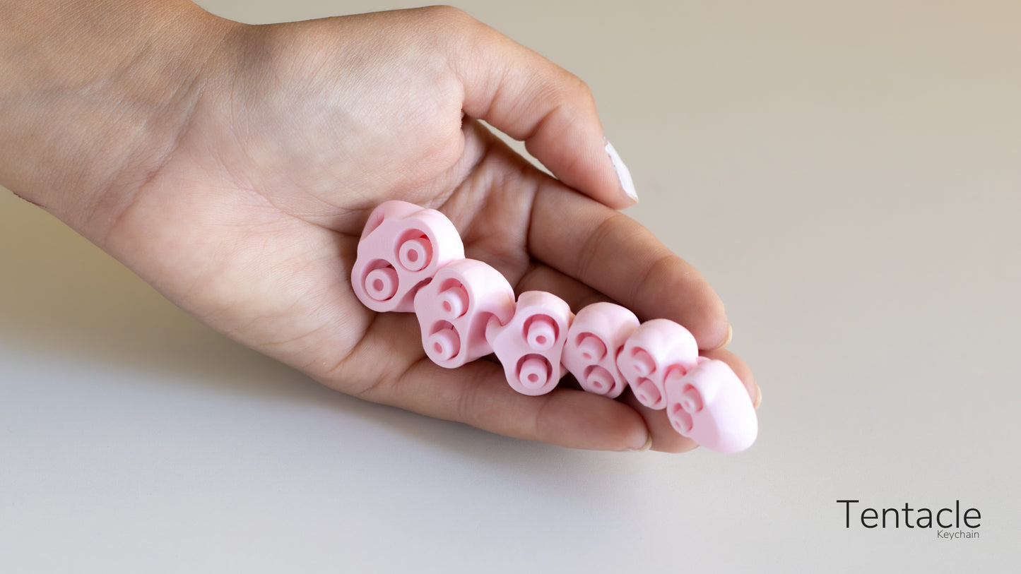 a hand is holding a small pink object