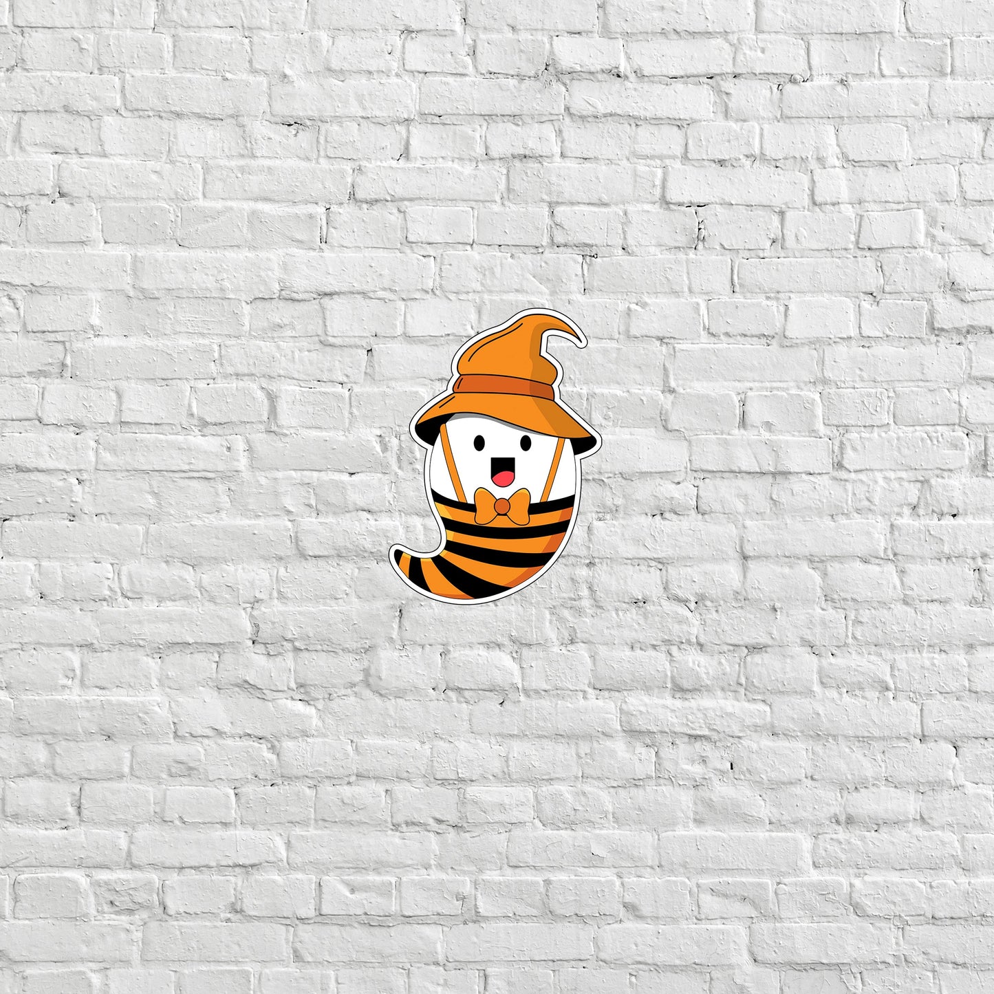 a white brick wall with a sticker of a bee wearing a hat