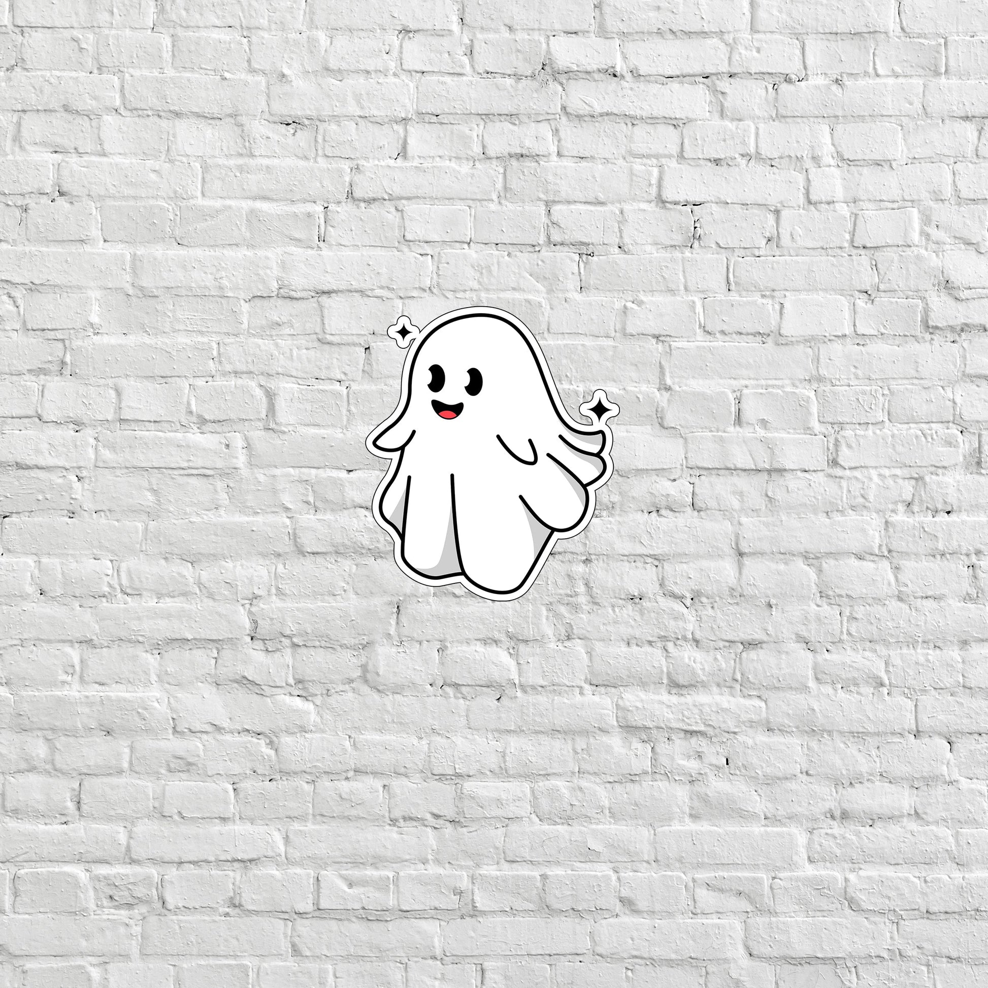 a white brick wall with a ghost sticker on it