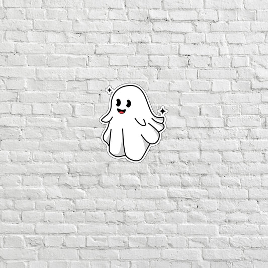 a white brick wall with a ghost sticker on it