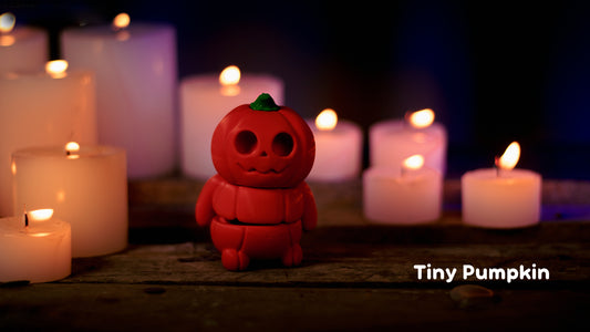 a red toy sitting in front of many lit candles