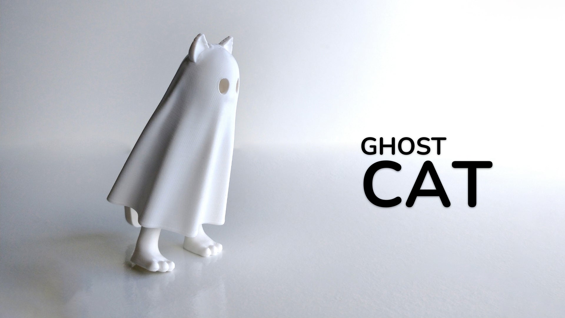 a white cat figurine with the words ghost cat on it