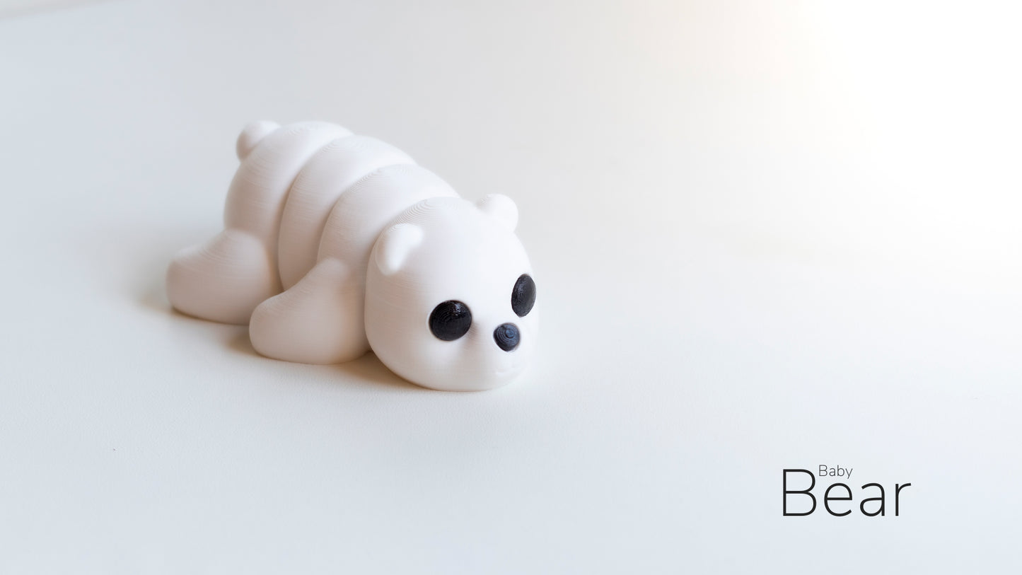 a small white toy laying on top of a white table