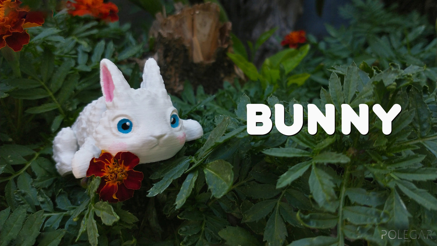 a white bunny with blue eyes sitting in a bush