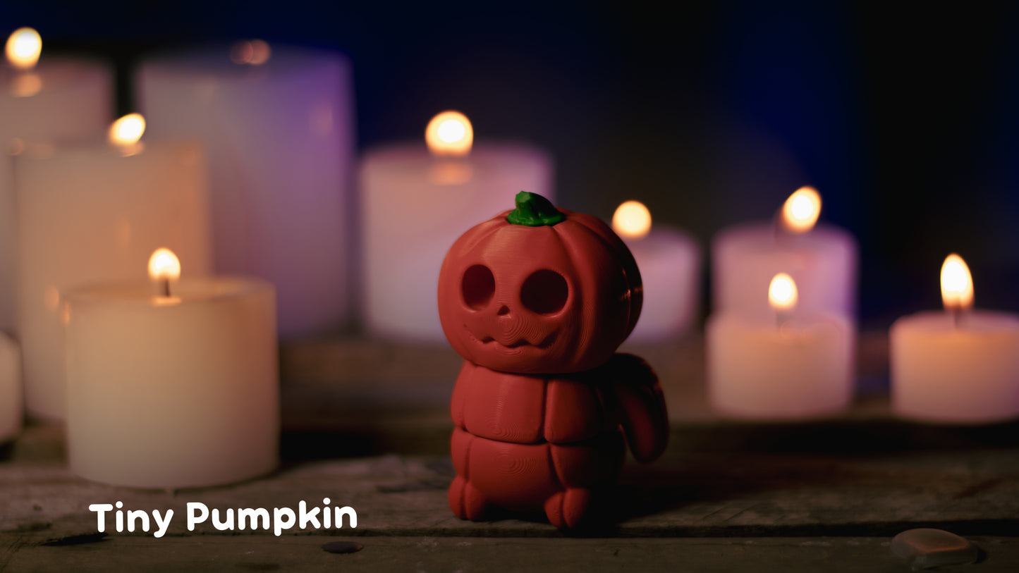 a toy pumpkin sitting in front of many lit candles