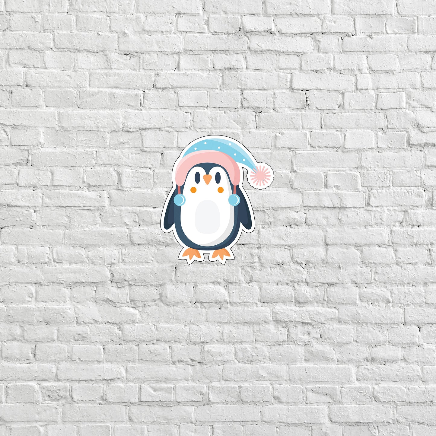 a penguin with a pink hat on a white brick wall