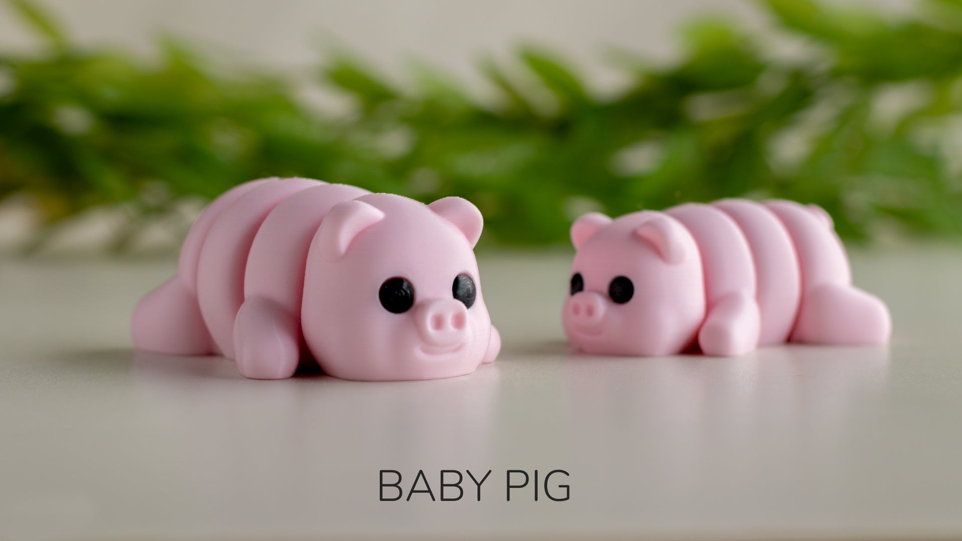 a couple of pink pig figurines sitting on top of a table