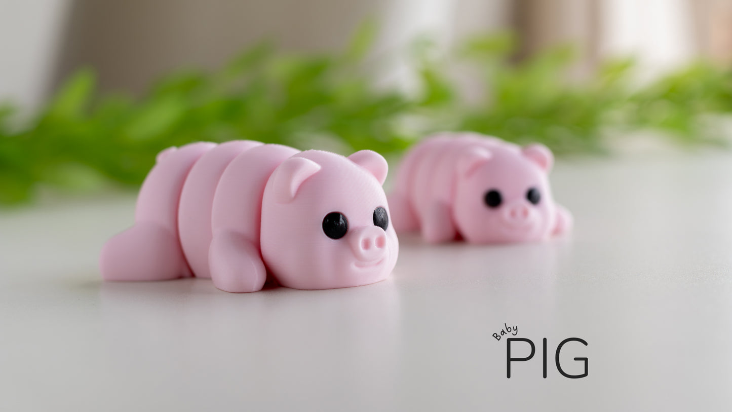 a couple of pink pigs sitting on top of a table