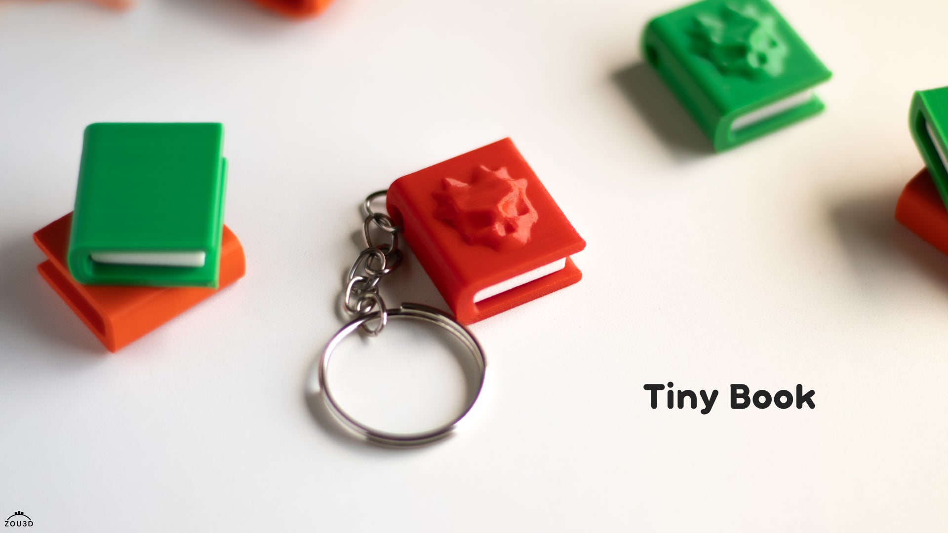 a tiny book keychain with a cat on it