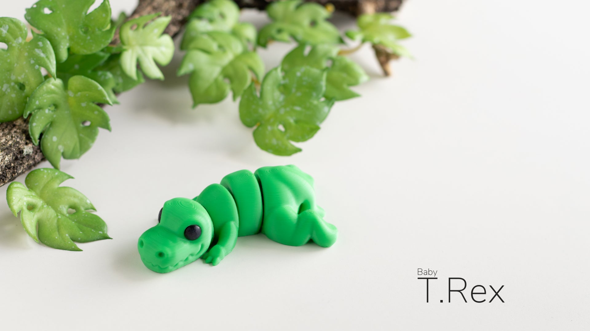 a close up of a toy caterpillar on a white surface