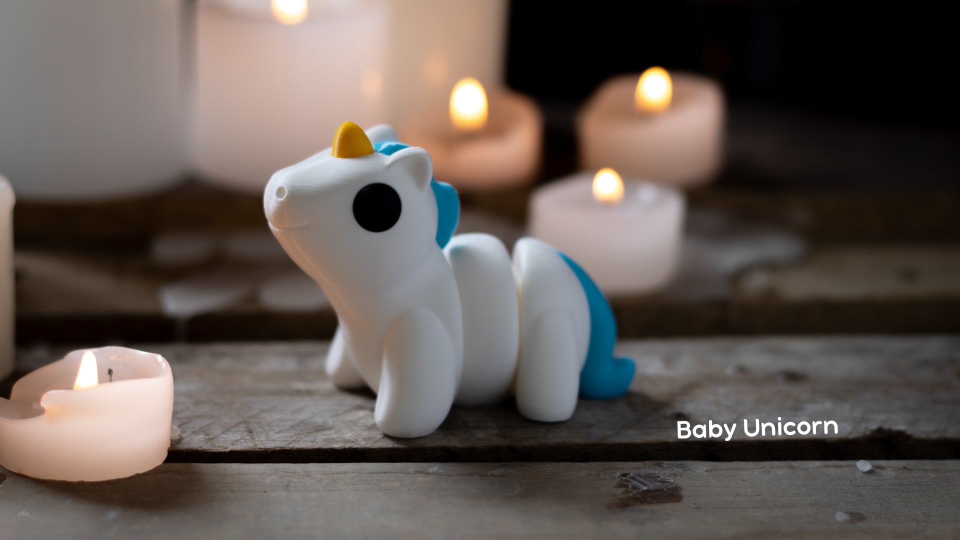 a small toy horse sitting next to candles