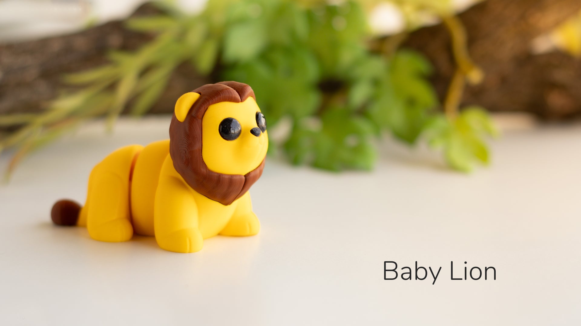 a toy lion sitting on top of a white table