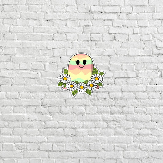 a white brick wall with a sticker of a bird and daisies