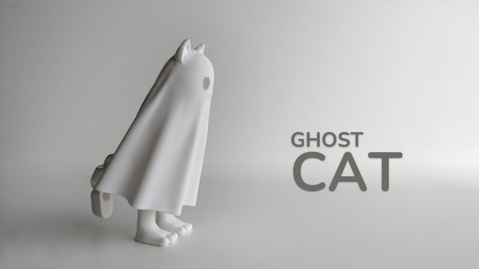 a ghost cat figurine with the word ghost cat below it