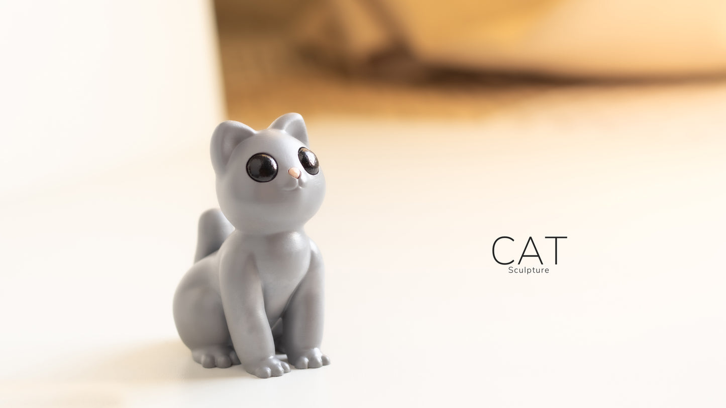 a cat figurine sitting on a white surface