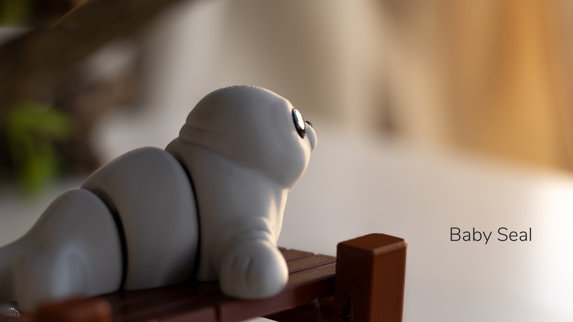 a baby seal toy sitting on a wooden bench