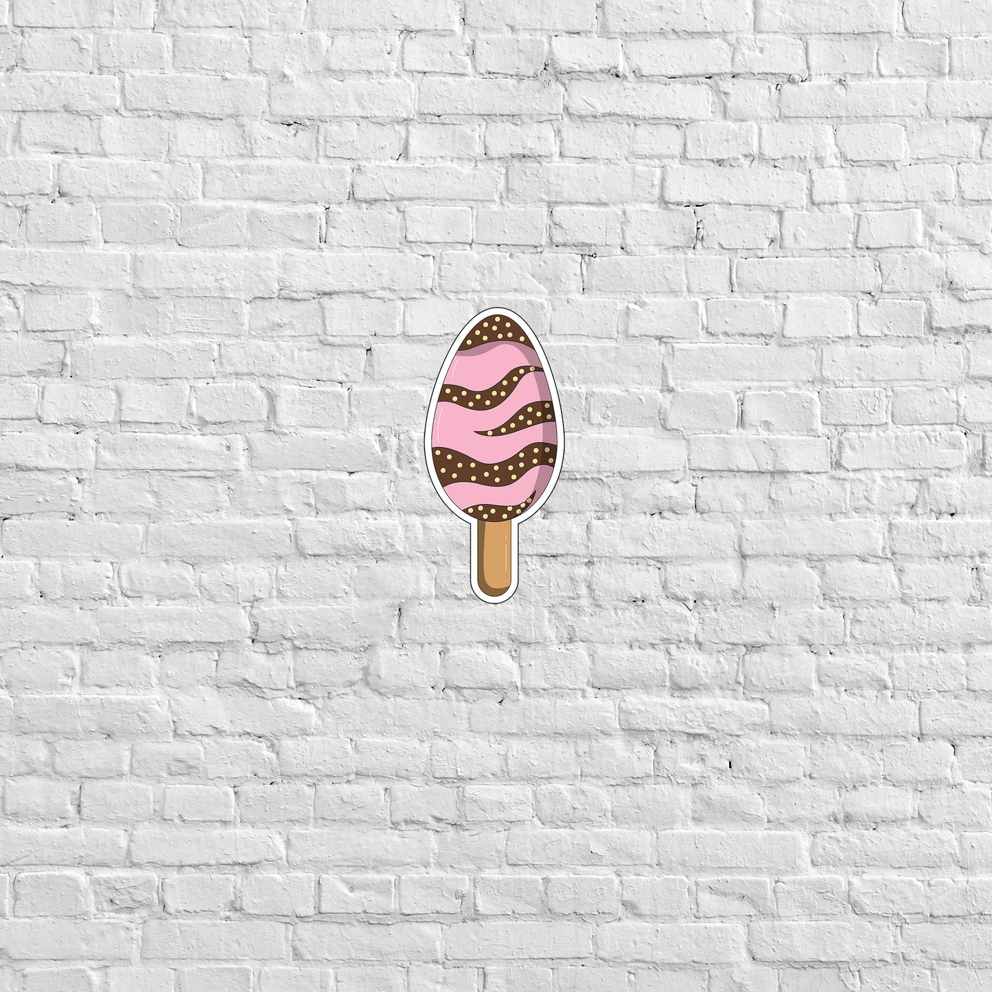 a white brick wall with a pink ice cream on it