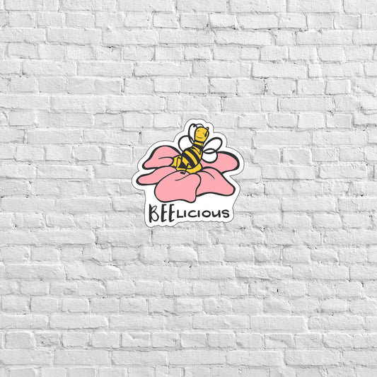 a white brick wall with a sticker of a bee on a pink flower