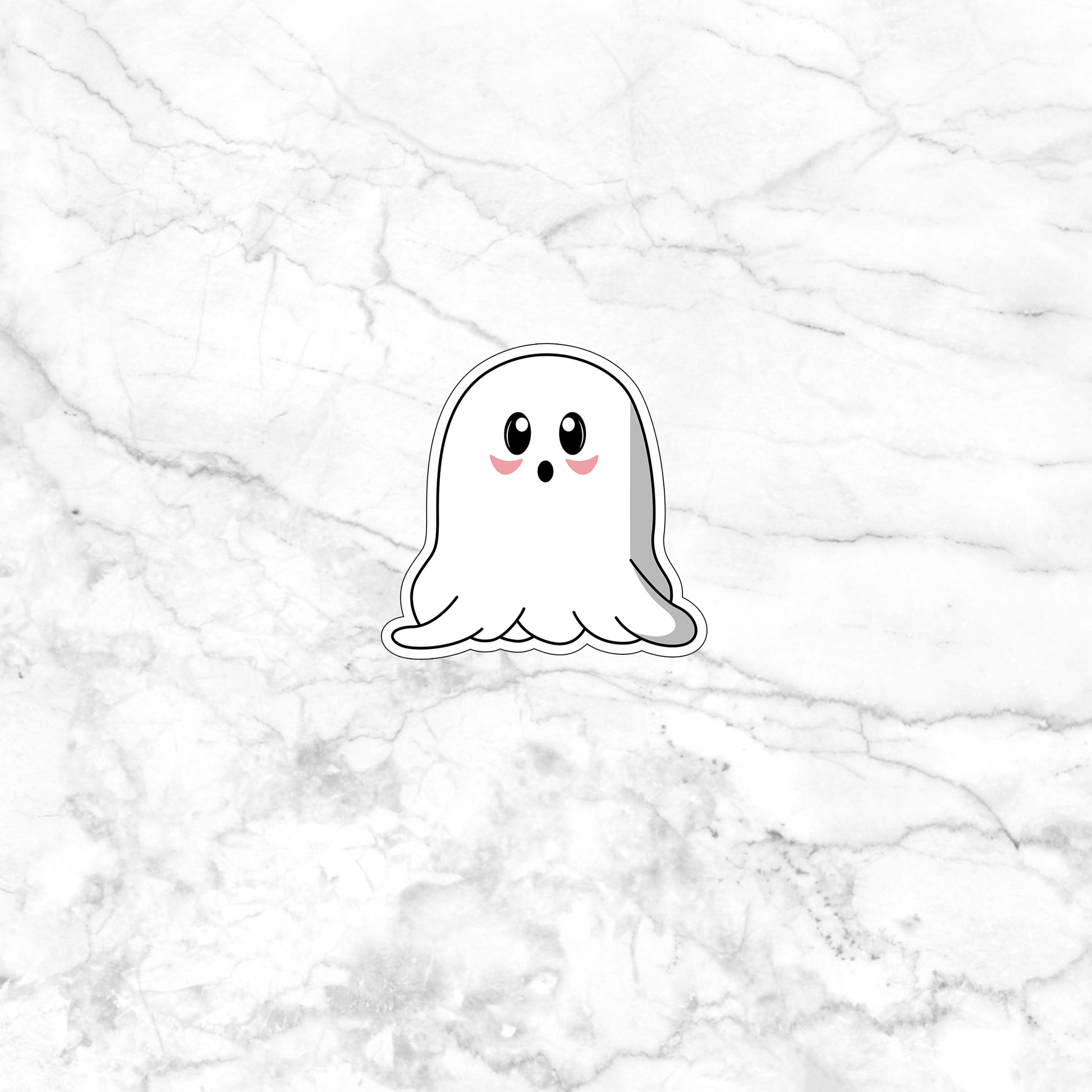 a sticker of a ghost on a marble surface