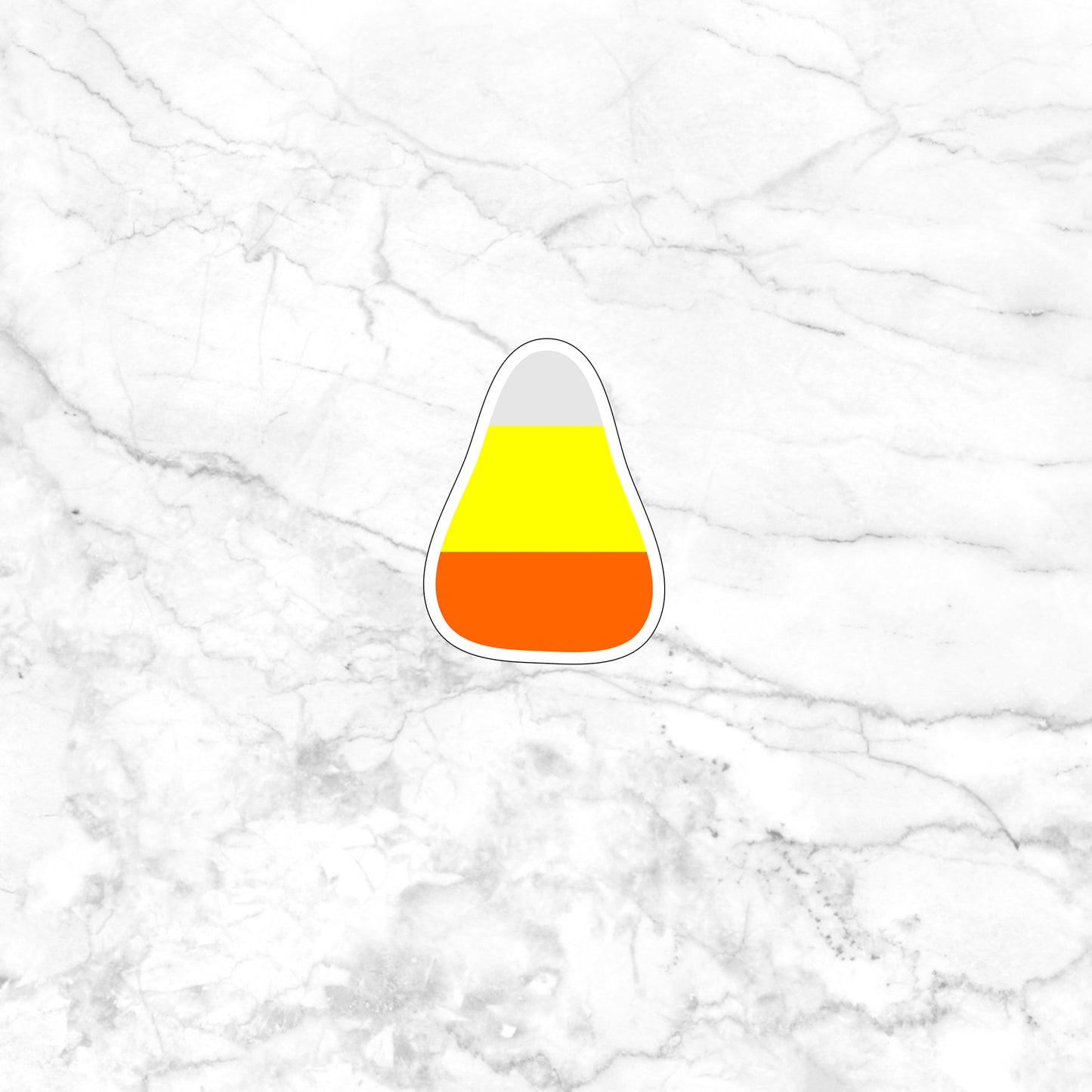 a sticker of a candy corn on a marble surface