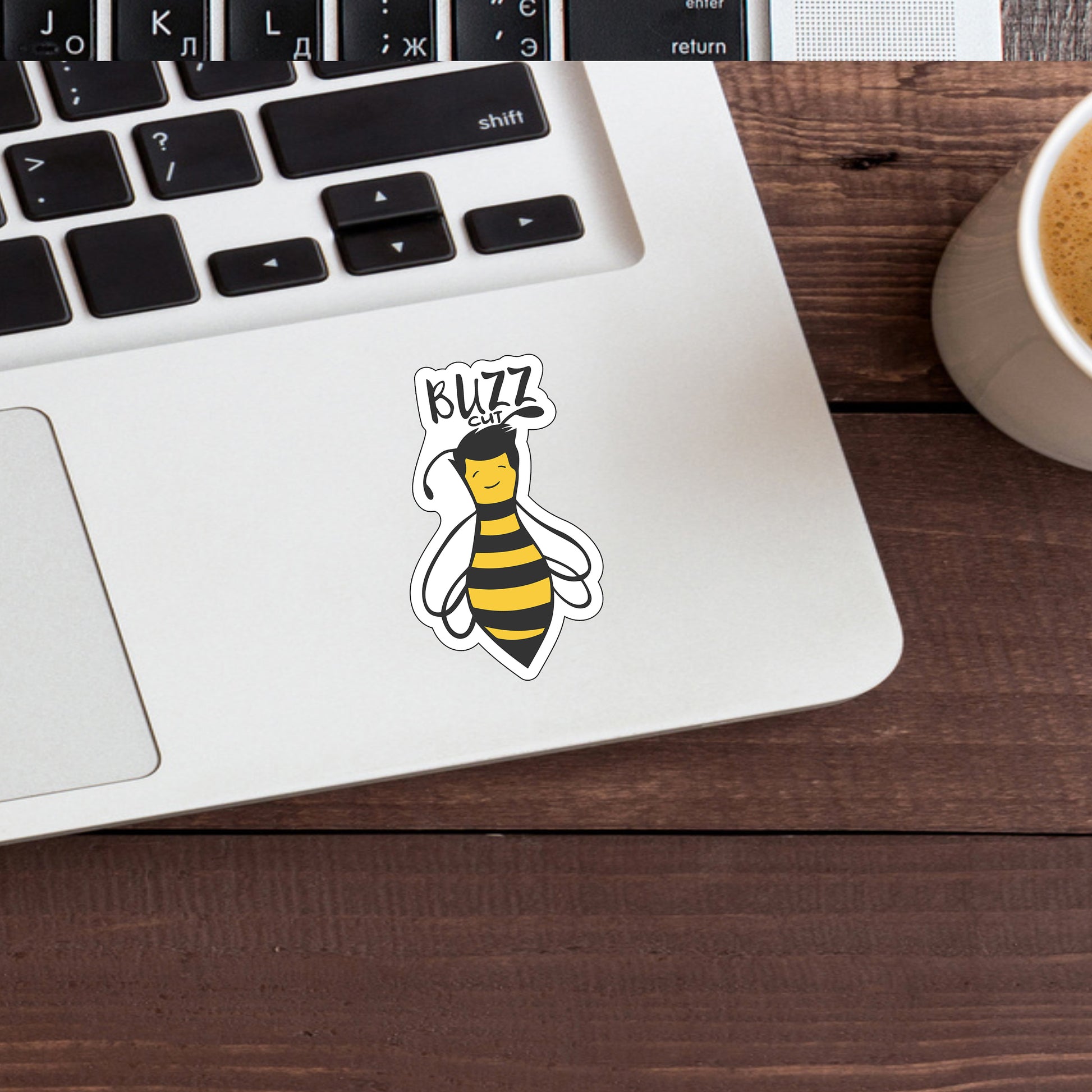 a laptop with a sticker of a bee on it