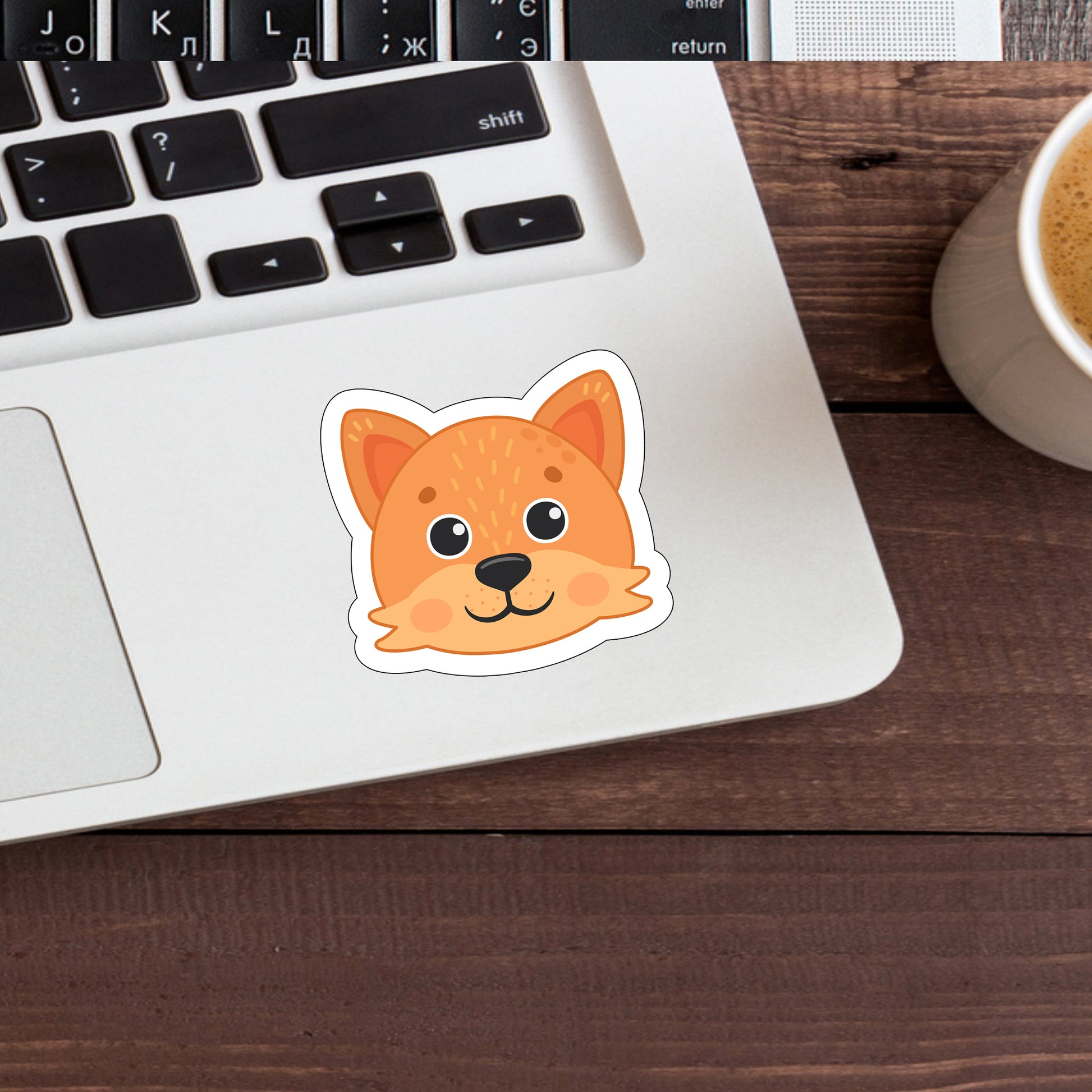 a cup of coffee and a sticker of a dog