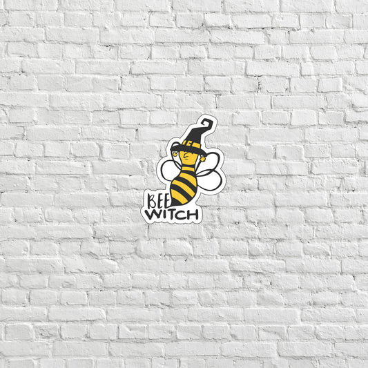 a white brick wall with a bee sticker on it