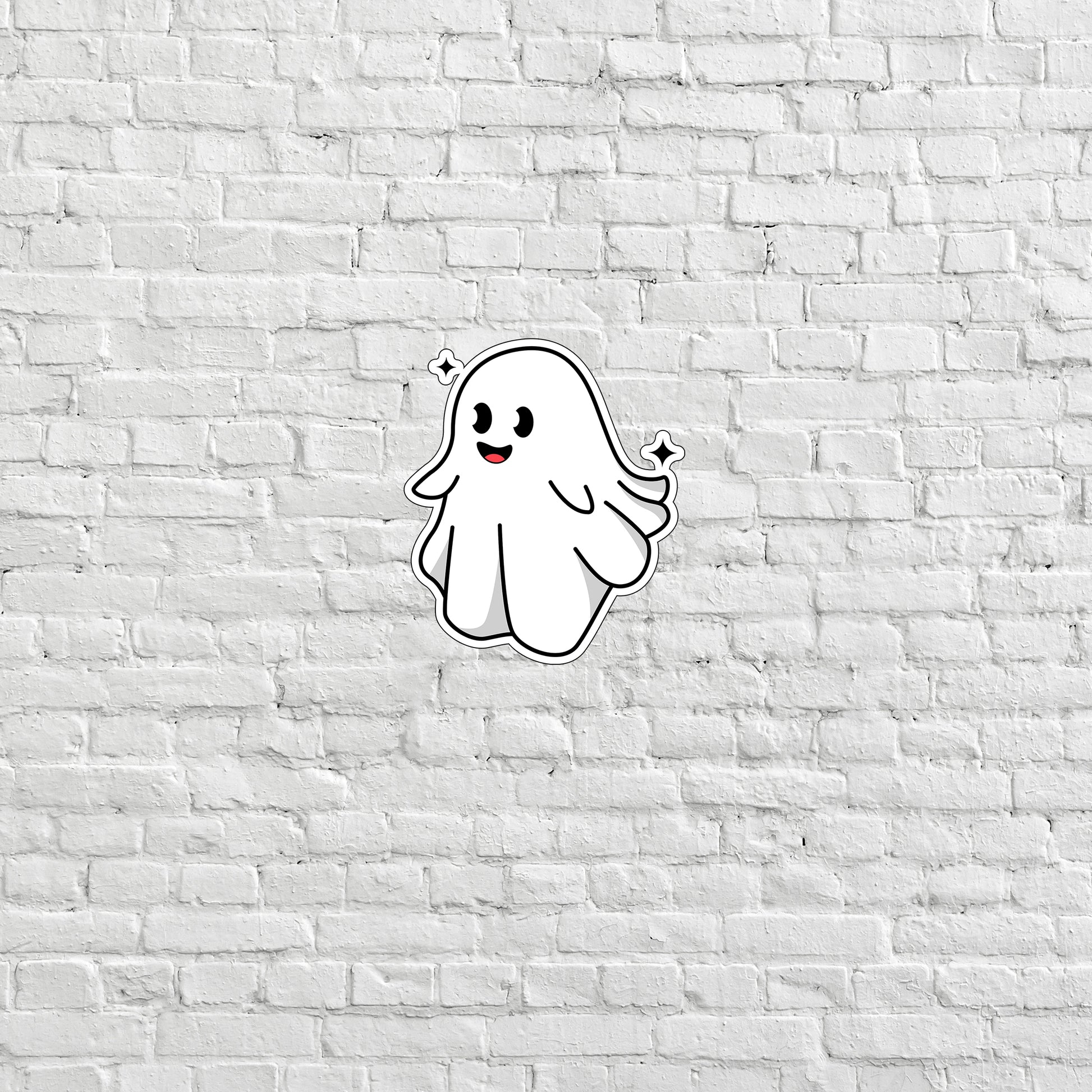 a white brick wall with a ghost sticker on it