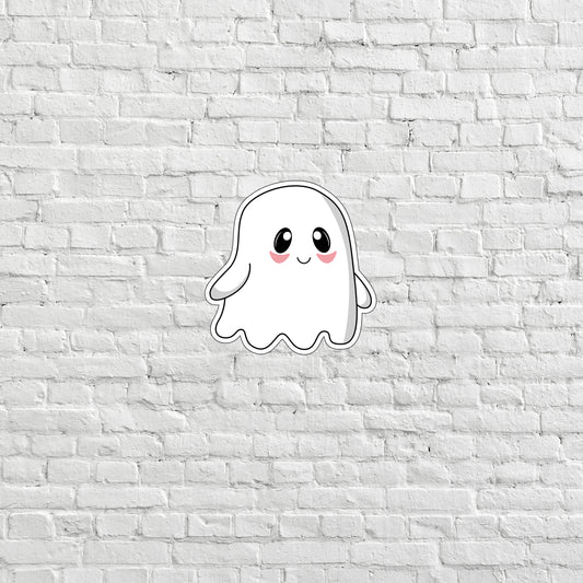 a sticker of a ghost on a white brick wall