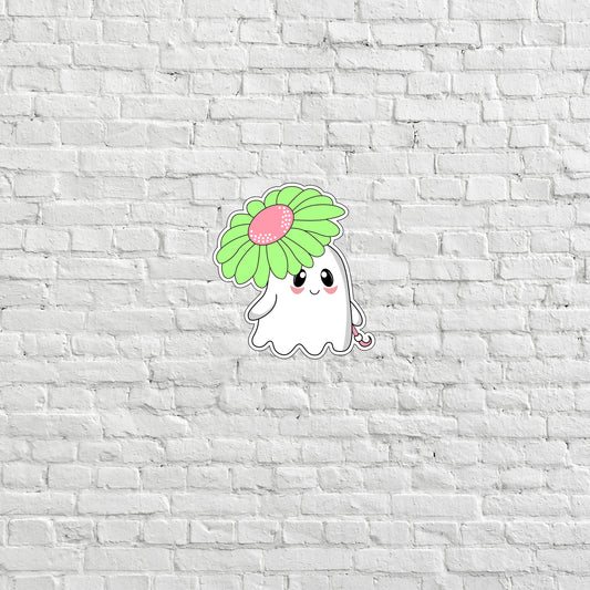 a white brick wall with a sticker of a ghost holding a flower