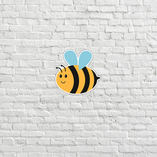 a sticker of a bee on a white brick wall