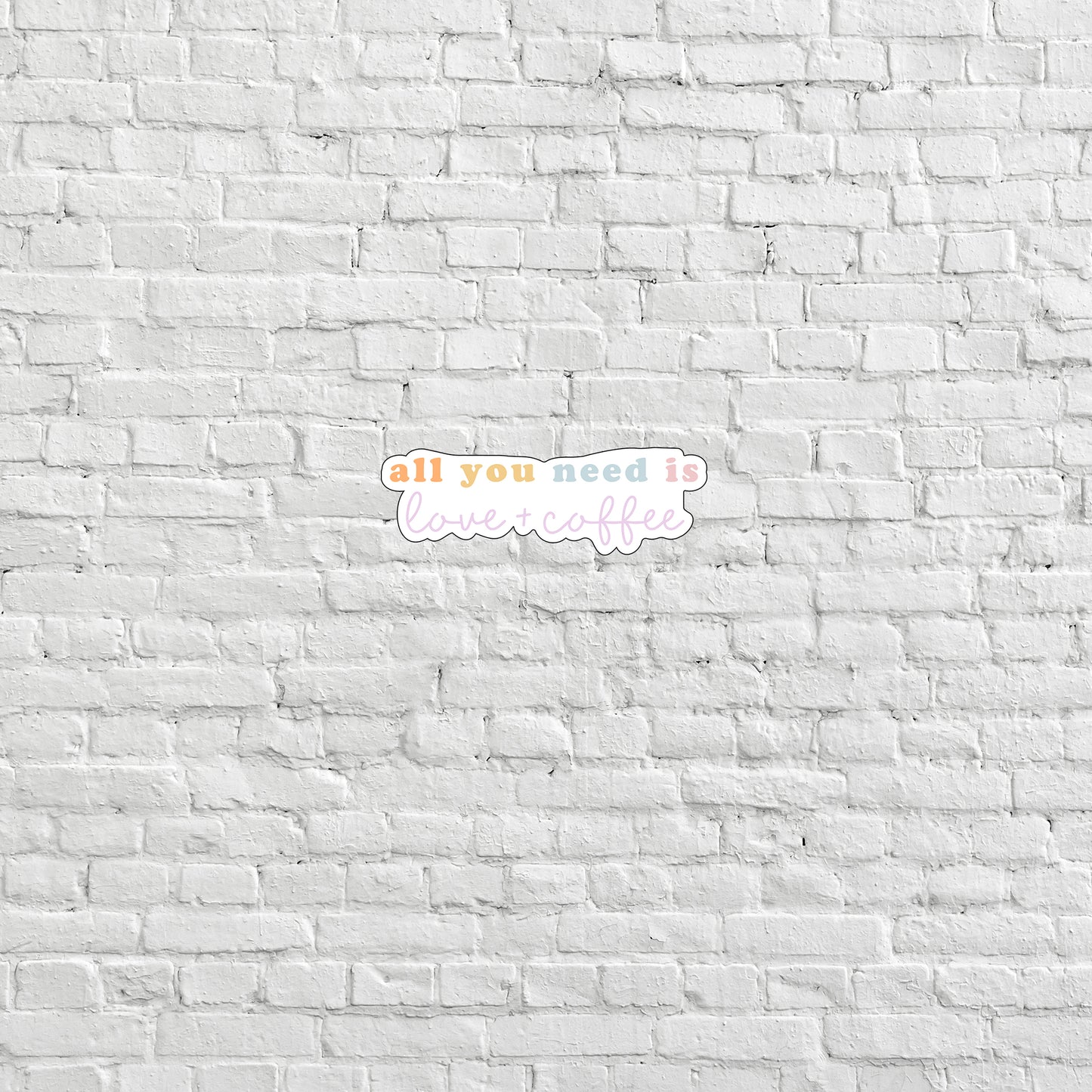 a white brick wall with the words all you need is love written on it