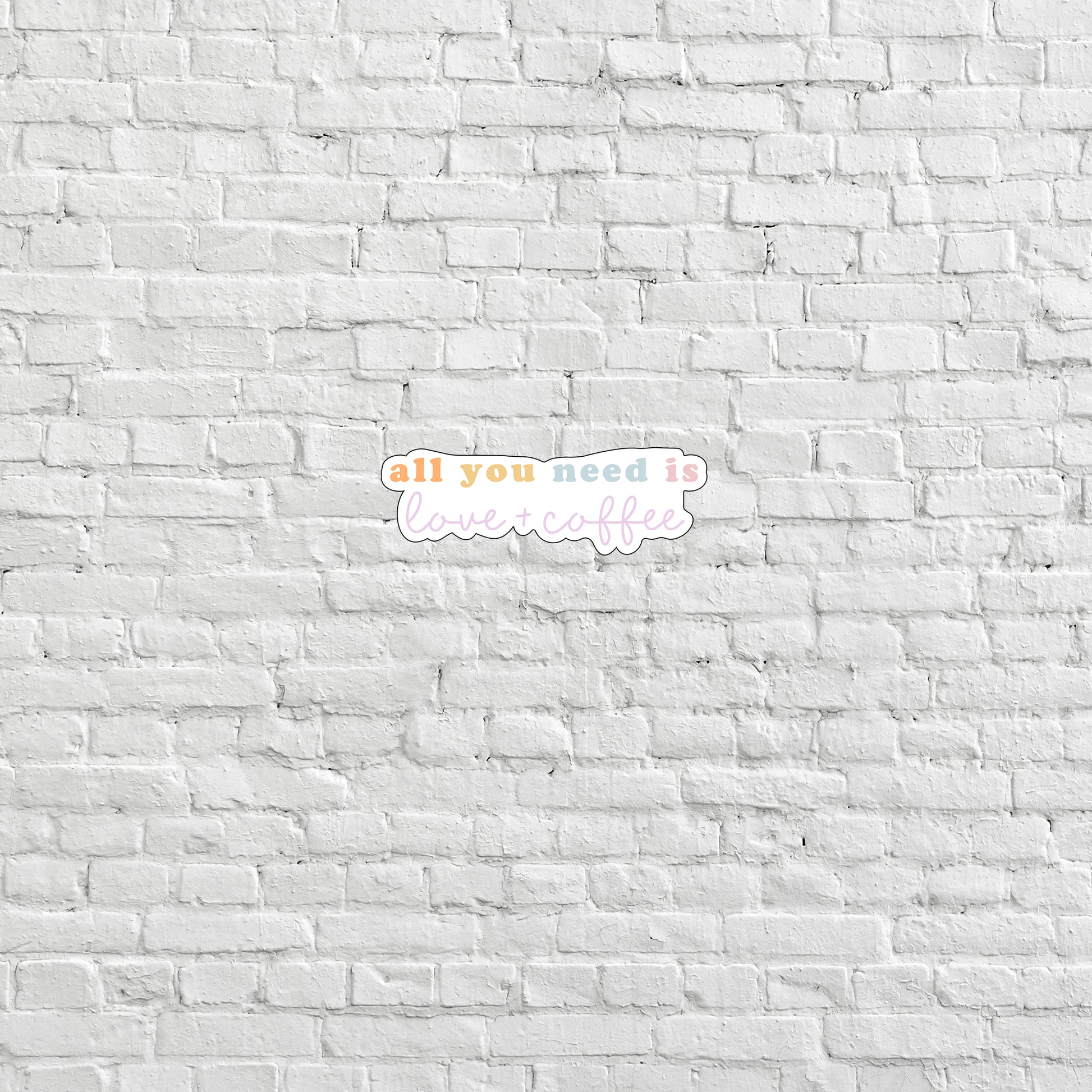 a white brick wall with the words all you need is love written on it