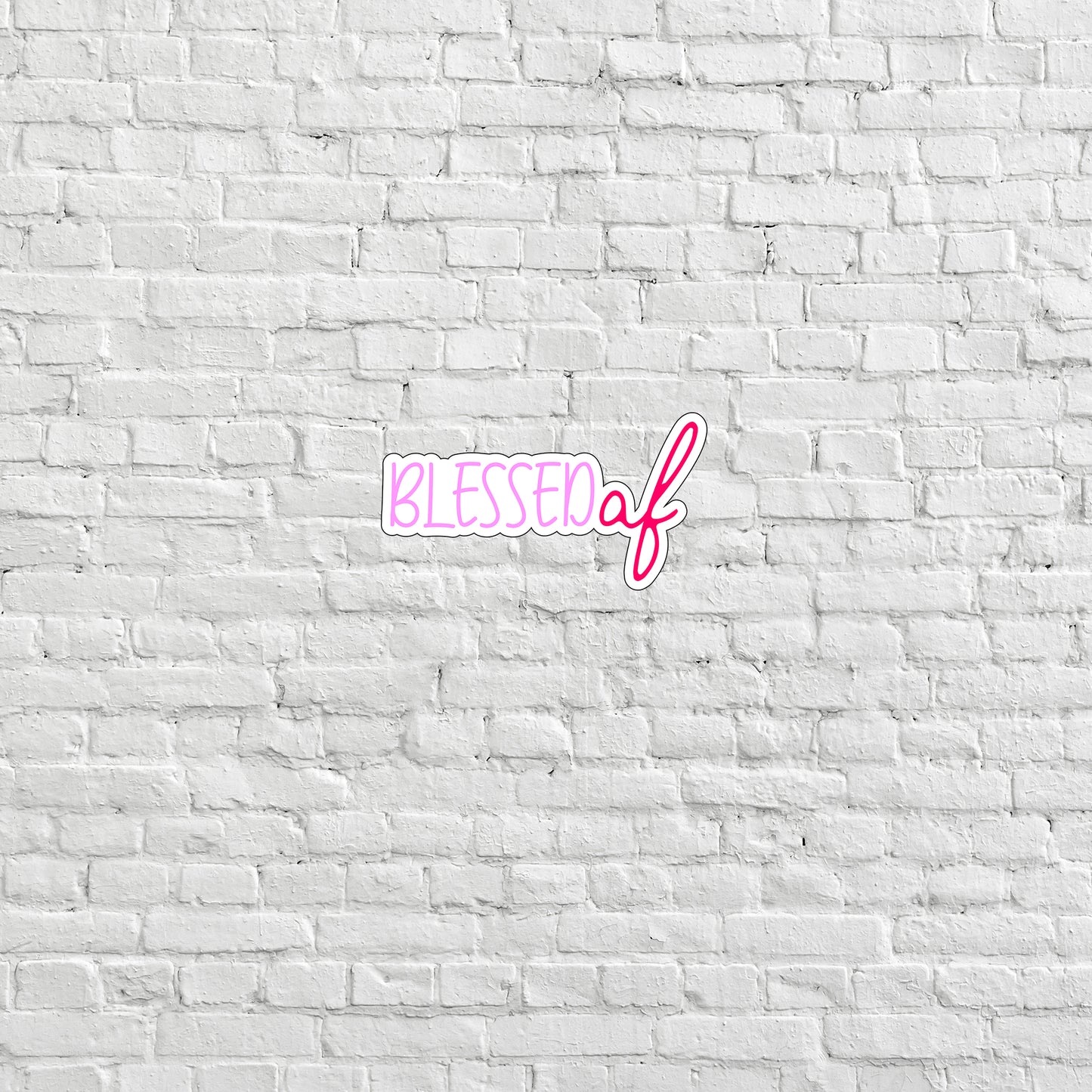 a white brick wall with a pink lettering on it