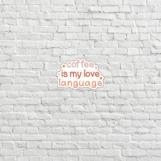 coffee is my love language sticker on a white brick wall