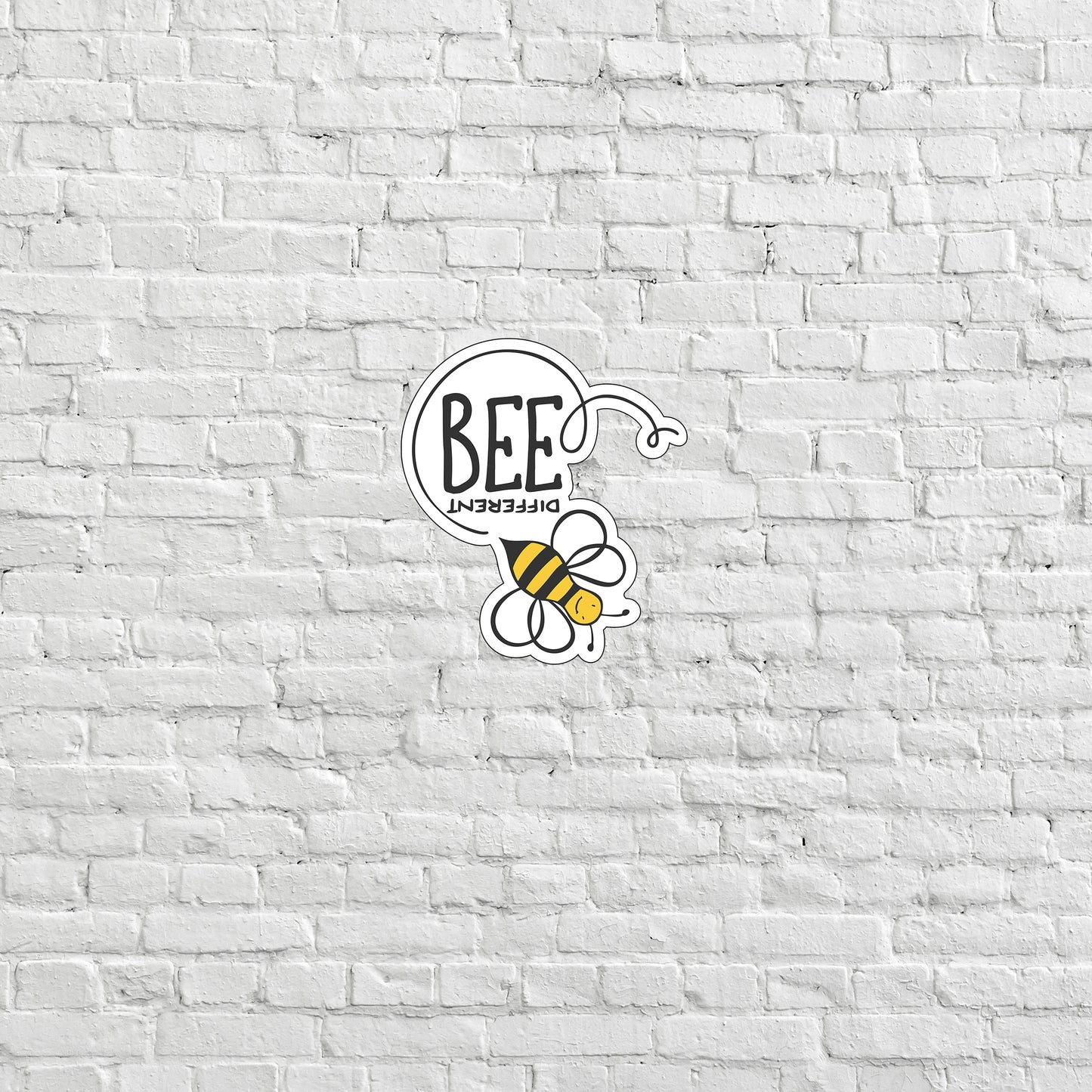 a white brick wall with a bee sticker on it