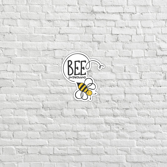 a white brick wall with a bee sticker on it