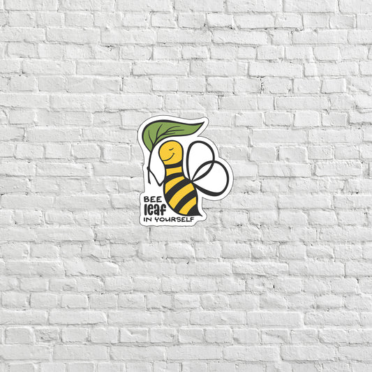 a white brick wall with a bee sticker on it