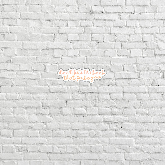 a white brick wall with a neon sign on it