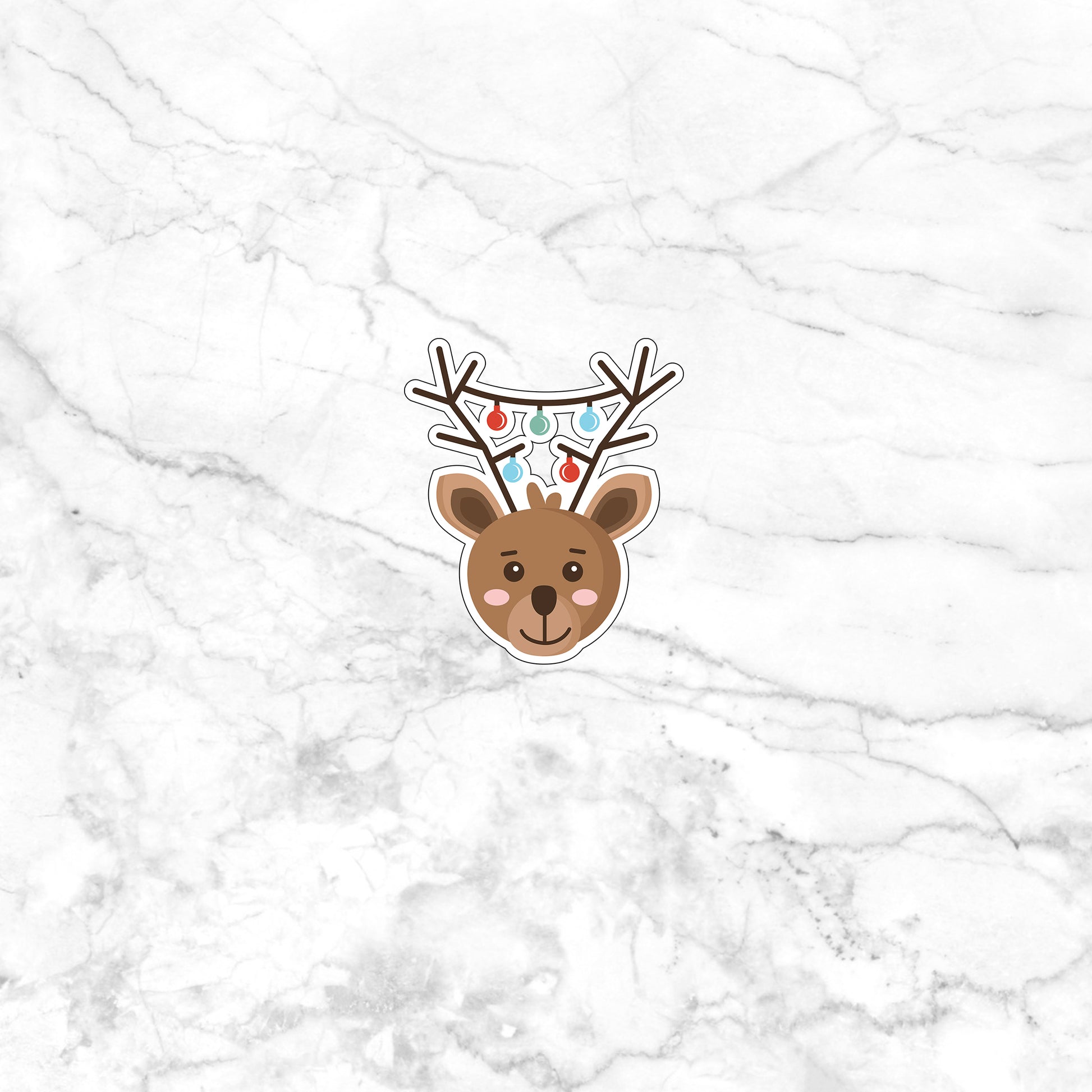 a white marble wall with a sticker of a reindeer's head