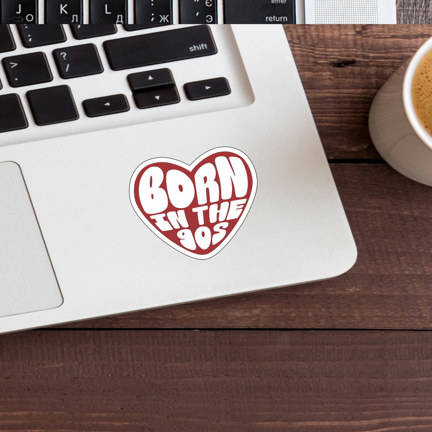 a laptop computer sitting on top of a desk next to a cup of coffee