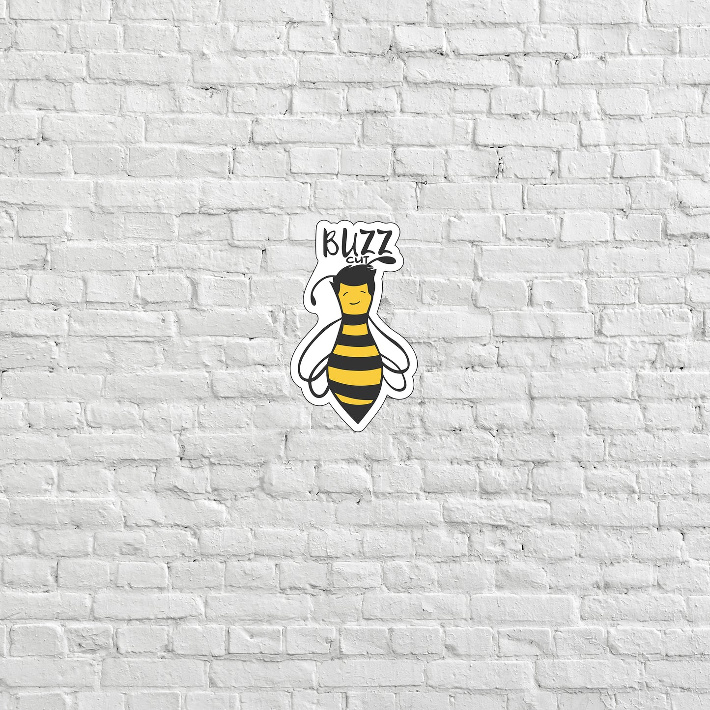 a white brick wall with a sticker of a bee on it