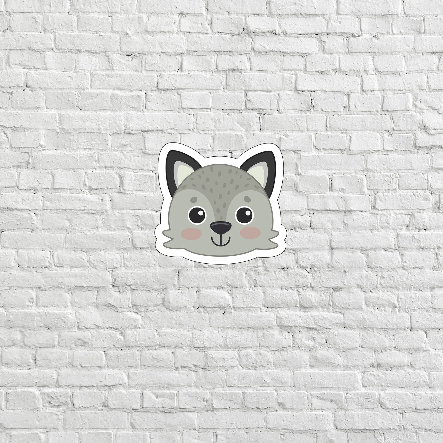 a sticker of a cat on a white brick wall