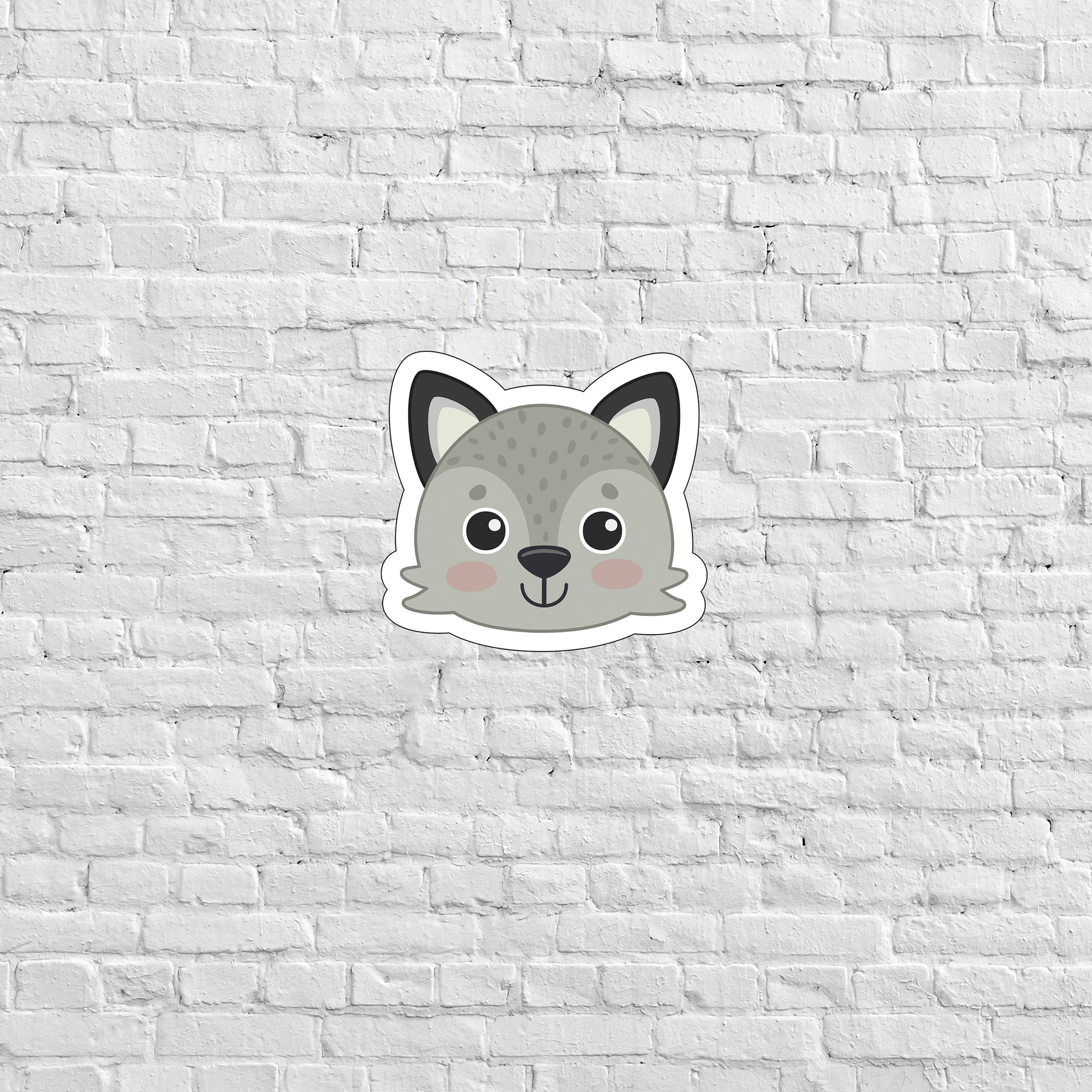 a sticker of a cat on a white brick wall