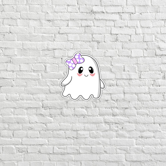 a white brick wall with a sticker of a ghost