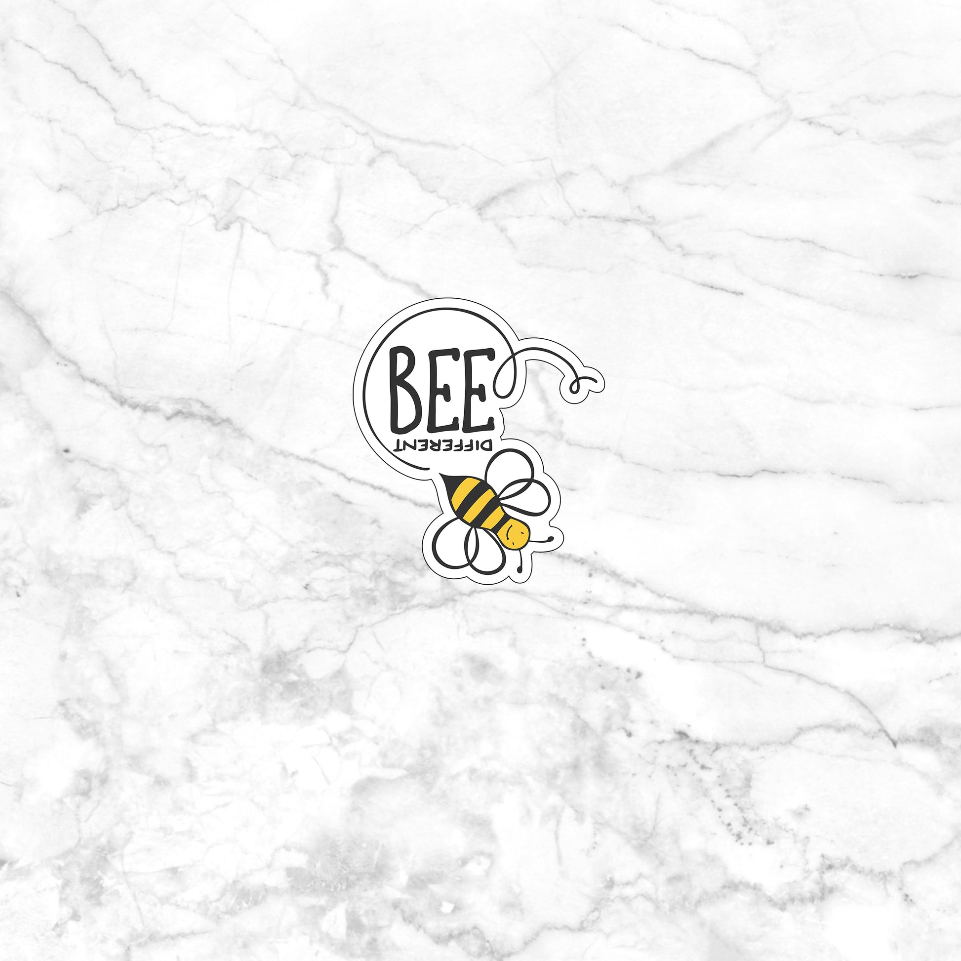 a white marble wall with a bee sticker on it